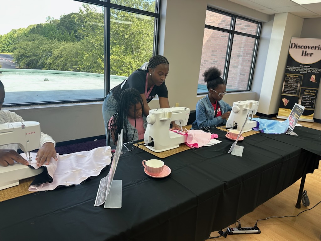 Girls practicing sewing skills together